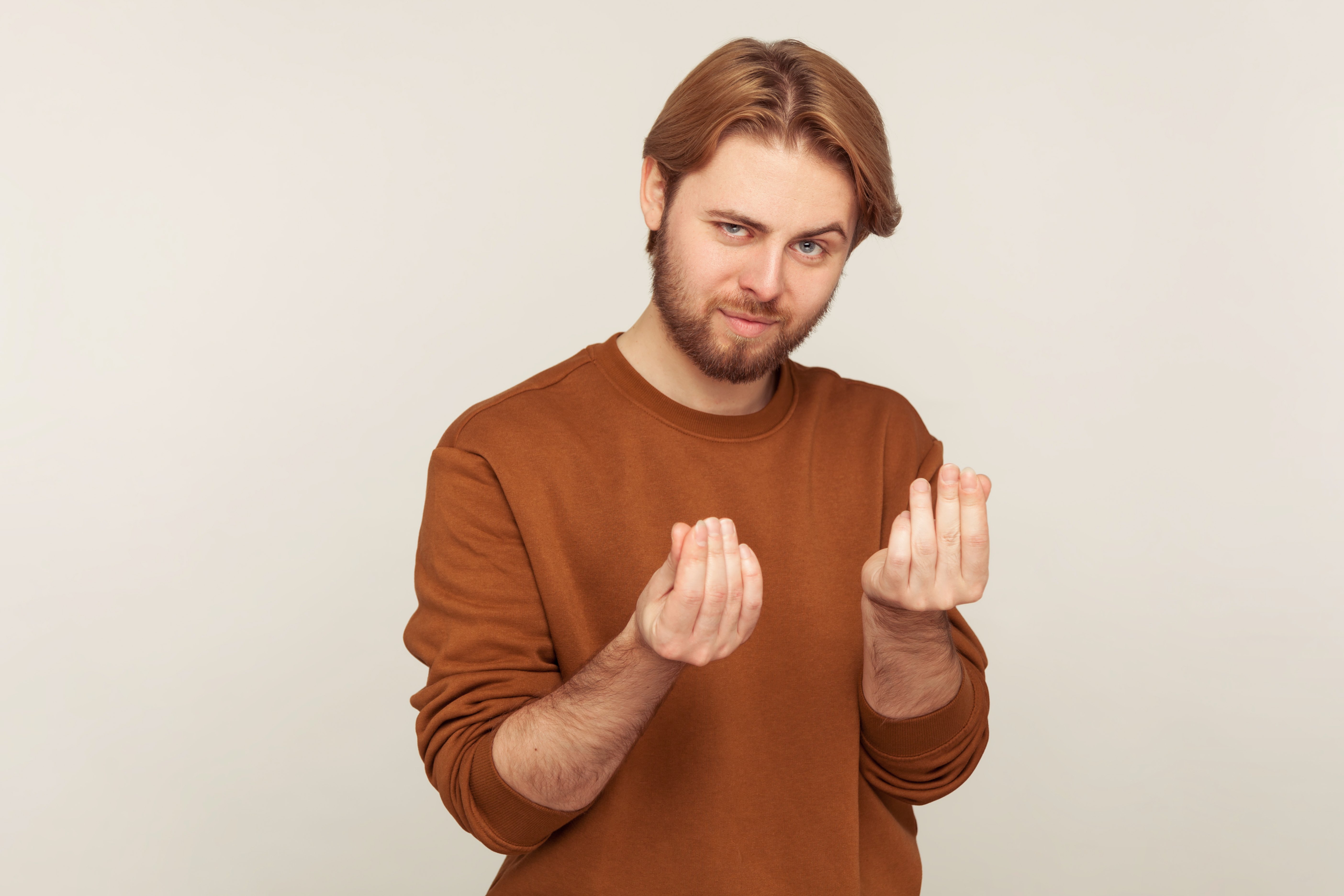 portrait-smart-handsome-bearded-businessman-stylish-sweatshirt-showing-money-gesture-planning-big-income_Botkeeper