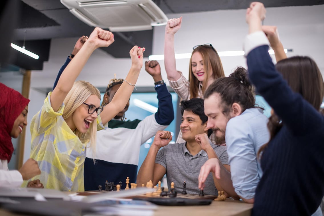 multiethnic-group-business-people-playing-chess-while-having-break-modern-startup-office-botkeeper