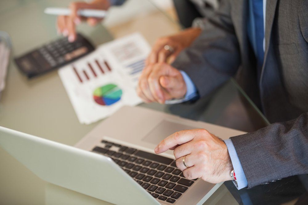 A businessman showing things on his laptop